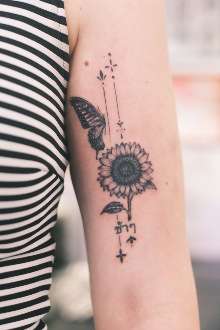 Fineline: Botanik, Sonne & Pfeil am Arm.